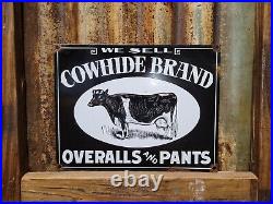 Vintage Cowhide Overalls Porcelain Sign Cowboy Rodeo Pants Clothing Oil Gas Cow